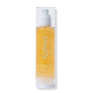 A clear bottle of the goldtinted Kopari Sun Shield Body Glow Gel SPF 50 on a white background
