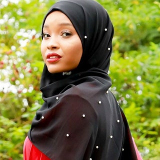 Urban Modesty Black Pearl Chiffon Hijab model looking over her shoulder wearing black hijab embellished with pearls with...